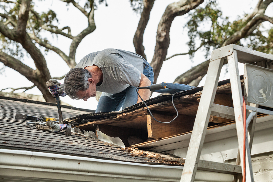 man repairing roof