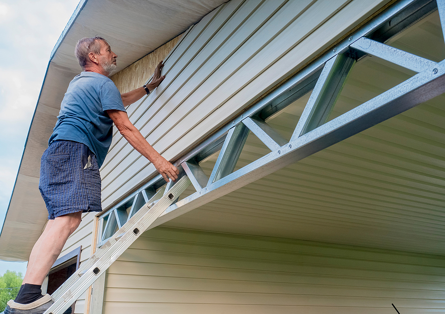 man working on a siding repair